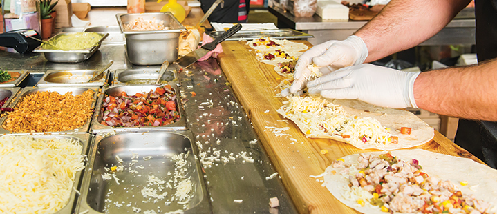 truck chef preparing sushi burritos in a table bar